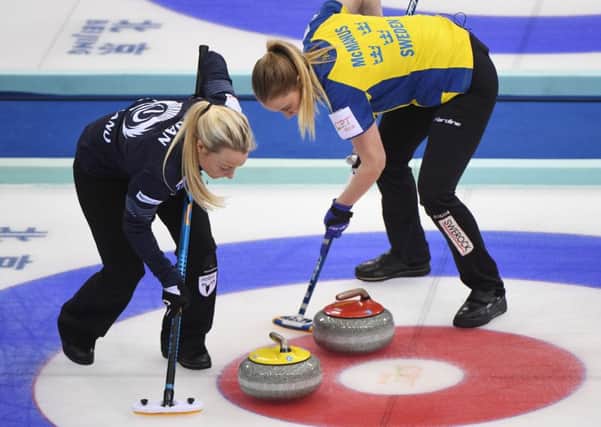 Scotland's Anna Sloan, left, and Sweden's Sara McManus sweep during their play-off at the Women's Curling World Championships. Picture: Getty Images