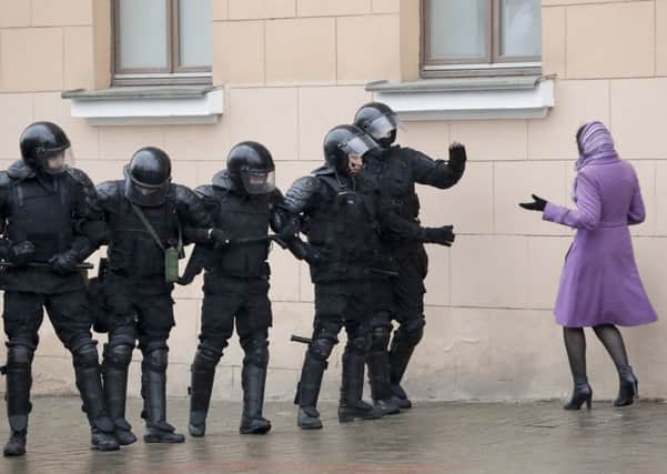 A woman confronts police officers blocking a street during an opposition rally in Minsk. Photograph: AP