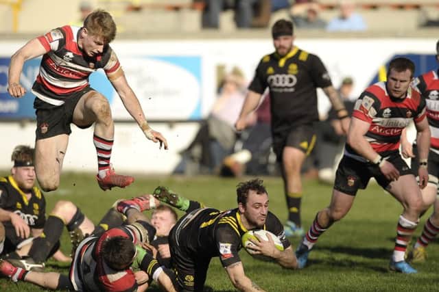 Harry Burr of Stirling County slides in to tackle Melroses Austin Lockington in yesterdays semi-final. Picture: Neil Hanna