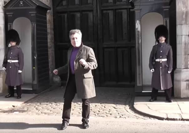 The male tourist dances in comic fashion before a Scots guardsmen makes him think again. Picture: lokirna md45/YouTube