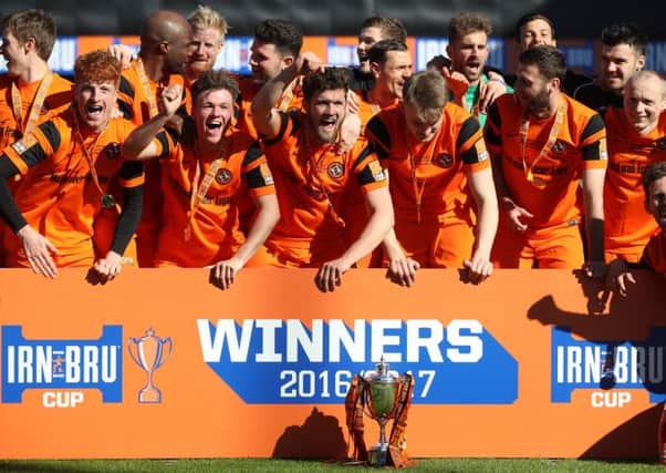 Dundee United celebrate after receiving the Irn Bru Challenge Cup. Picture: Getty.