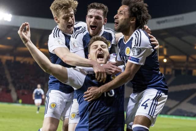 Chris Martin celebrates with team-mates after scoring Scotland's winning goal. Picture: Alan Rennie/Sportpix