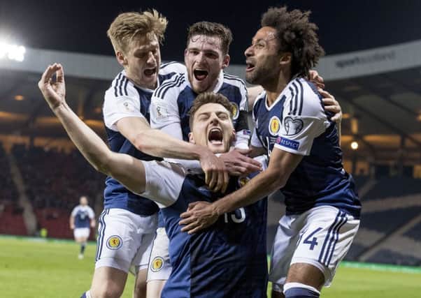 Chris Martin celebrates with team-mates after scoring Scotland's winning goal. Picture: Alan Rennie/Sportpix