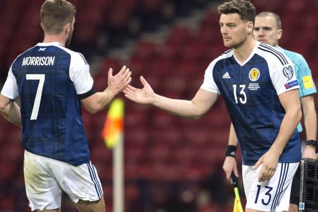 With boos ringing in his ears, Chris Martin (right) takes the field against Slovenia. Picture: SNS