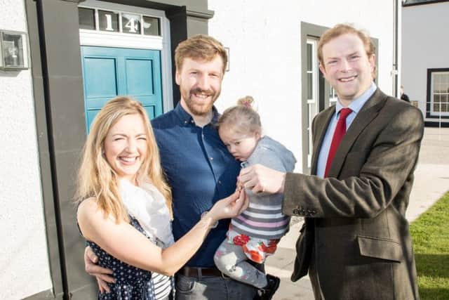 Madeline and Jonathan Hewitt, along with daughter Millie move into their new house on the Tornagrain new town development. Pictured with John Stuart, Chairman of Moray Estates.