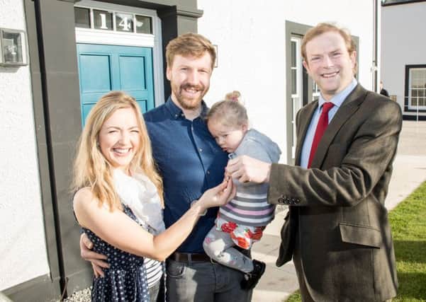 Madeline and Jonathan  Hewitt, along with daughter Millie move into their new house on the Tornagrain new town development. Pictured with  John Stuart, Chairman of Moray Estates.