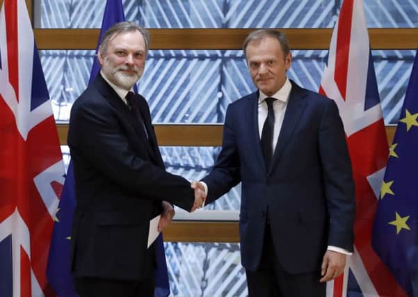 Britain's permanent representative to the EU, Tim Barrow, hand delivers Theresa May's Article 50 letter to European Council President Donald Tusk. Picture: Yves Herman/Pool Photo via AP