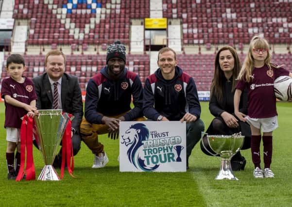 Young Hearts fans Jojo, left, and Skye, right, are pictured with Craig Wilson of Big Hearts, Isma Goncalves, Malaury Martin and SPFL Trust general manager Nicky Reid. Picture:

Craig Watson