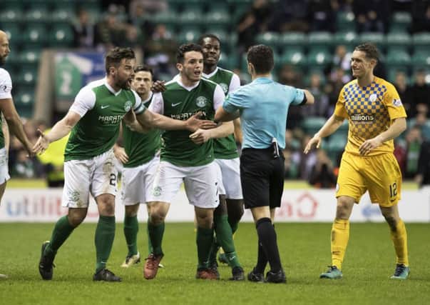 Hibernian players surround the referee after Darren McGregor (second from right) clashed with Morton's Kudus Oyenuga. Picture: Ross MacDonald/SNS