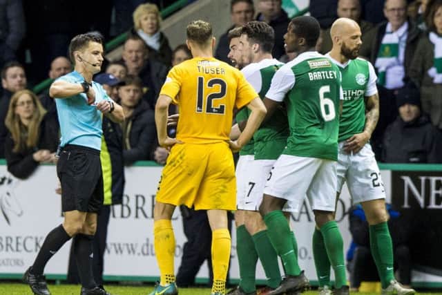 Referee Nick Walsh produces the red card for Hibs captain Darren McGregor. Picture: Alan Harvey/SNS