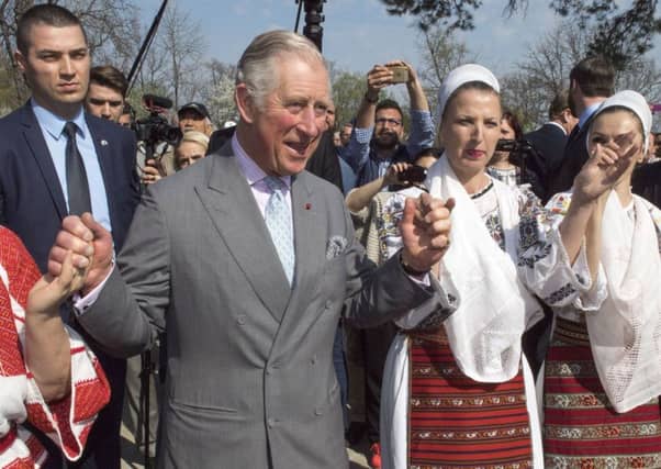 Prince Charles dances with Romanian dancers at a village museum on the second day of his nine day European tour (Photo by Arthur Edwards - WPA Pool/Getty Images)