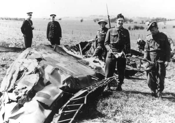 Soldiers and policemen in Eaglesham inspect the wreckage of the Messerschmitt ME-110 in which Nazi leader Rudolf Hess made his solo flight to Scotland. Picture: Hulton Archive/Getty Images.