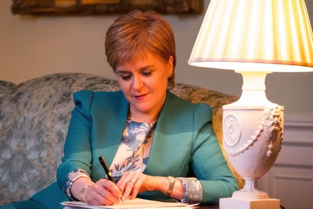 First Minister Nicola Sturgeon works on the final draft of her Section 30 letter to the Prime Minister Theresa May formally requesting a second Scottish independence referendum. Picture: Scottish Government
