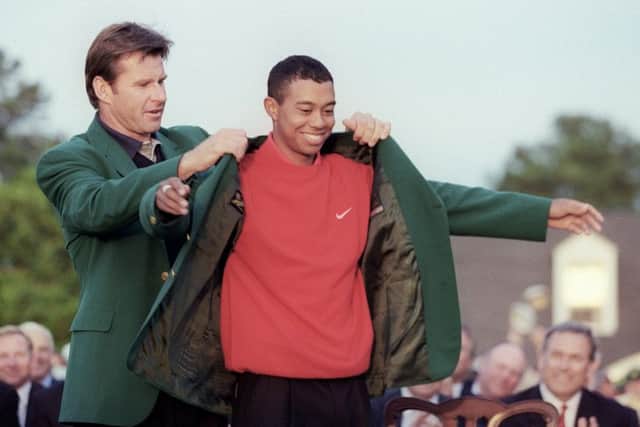Tiger Woods receives his Green Jacket from former champion Nick Faldo after his 18-under-par score won the 1997 Masters by a record margin of 12 shots. Picture: Timothy A Clary/Getty