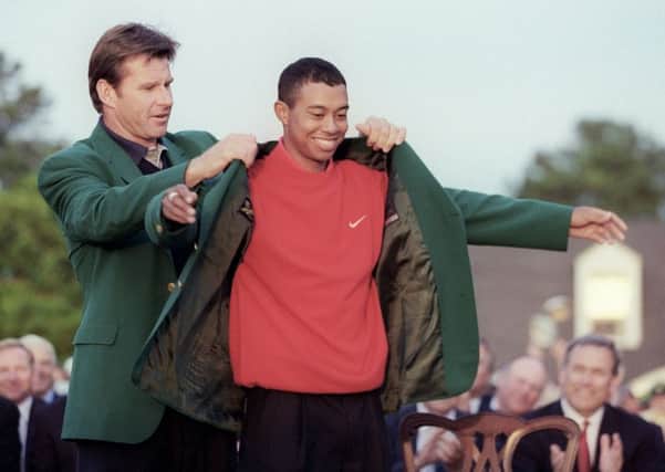 Tiger Woods receives his Green Jacket from former champion Nick Faldo after his 18-under-par score won the 1997 Masters by a record margin of 12 shots. Picture: Timothy A Clary/Getty