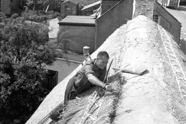 Wilf Pearce, travelling thatcher, at work on a thatched roof in Kirk Yetholm in the Borders, August 1971. Picture: Ian Brand/TSPL