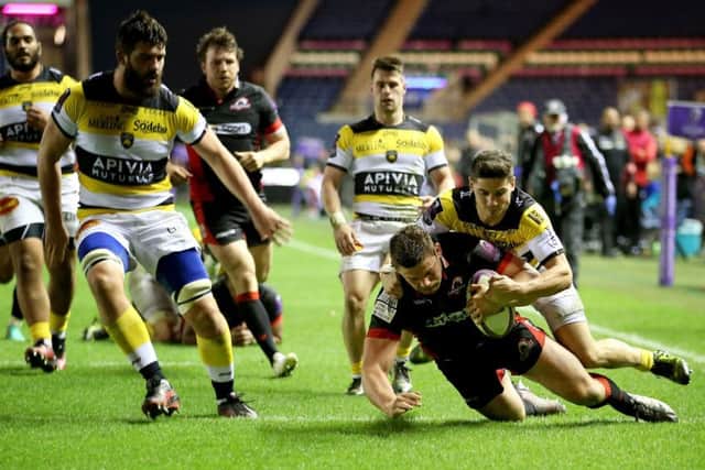 Edinburgh's Ross Ford beats La Rochelle's Steve Barry to score his side's second try. Picture: Jane Barlow/PA Wire