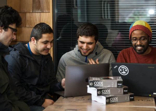 Mozafar Haider (far right) is one of the tutors on the coding course for refugees. He is seen here with fellow mentors and students.