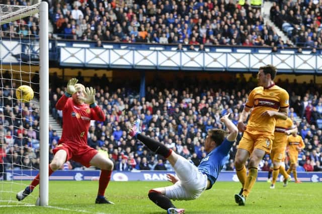 Joe Garner flicks the ball past Craig Samson from close range to resuce a point for Rangers. Picture: Rob Casey/SNS