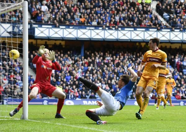Joe Garner flicks the ball past Craig Samson from close range to resuce a point for Rangers. Picture: Rob Casey/SNS