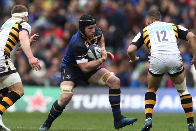 Leinsters Sean OBrien takes on  Wasps Thomas Young, left, and  the former Irish club favourite Jimmy Gopperth in yesterdays Dublin encounter.  Photograph: PA