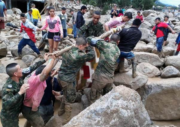 Soldiers and residents work together in rescue efforts in Mocoa, Colombia. Picture: AP