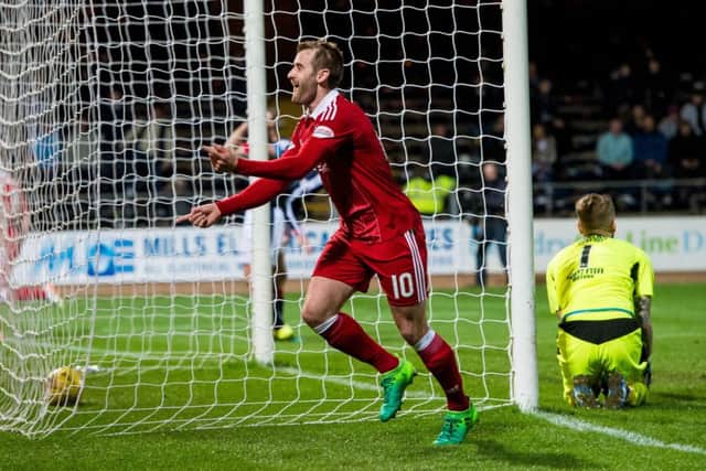 Niall McGinn celebrates one of his last goals in an Aberdeen shirt. Pic: SNS/Ross Parker