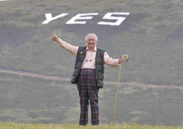 Peter de Vink stands in a field at his Home near Temple Midlothian with a giant yes sign on the hillside behind him. Picture: Ian Rutherford