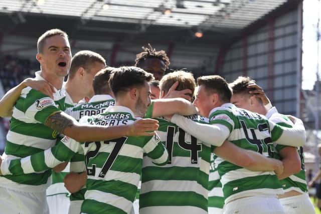 Celtic players pile on Stuart Armstrong after his goal makes it 3-0. Picture: SNS