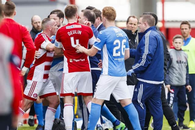 Tempers flare as the teams go into the dressing room at half-time. Picture: SNS