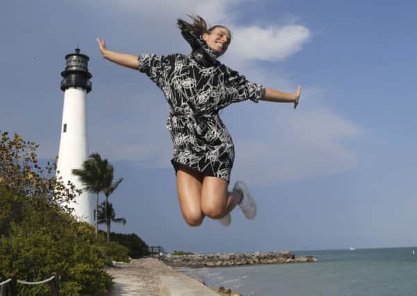 Johanna Konta enjoys her moment at the Cape Florida lighthouse after winning the Miami Open. Picture: AP.