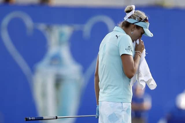 Lexi Thompson composes herself on 18th green during the final round of the LPGA Tour's ANA Inspiration golf tournament after earlier finding out she'd incurred a four-stroke penalty for a rules violation the previous day. Picture :Alex Gallardo/AP