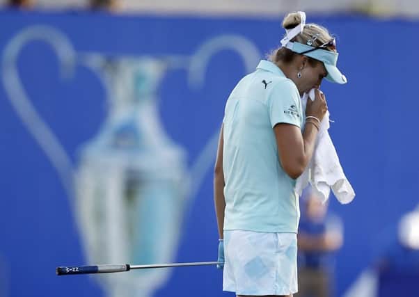 Lexi Thompson composes herself on 18th green during the final round of the LPGA Tour's ANA Inspiration golf tournament after earlier finding out she'd incurred a four-stroke penalty for a rules violation the previous day. Picture :Alex Gallardo/AP