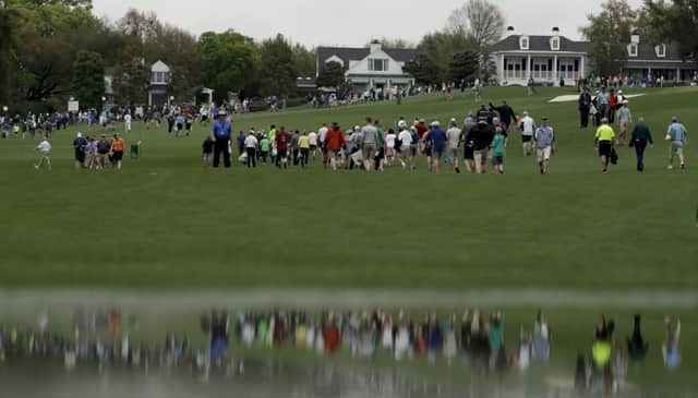Fans leave the course after a weather warning was issued during the first official practice day for the 81st Masters. Picture: AP