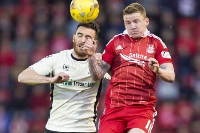 Inverness' Ross Draper, left, heads clear under pressure from Aberdeen winger Jonny Hayes. Picture: SNS