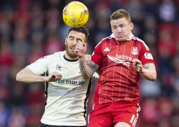 Inverness' Ross Draper, left, heads clear under pressure from Aberdeen winger Jonny Hayes. Picture: SNS