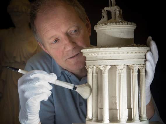Collections care officer Paul McAuley has a close look at architect Thomas Hamilton's design for the Burns Monument on Calton Hill.