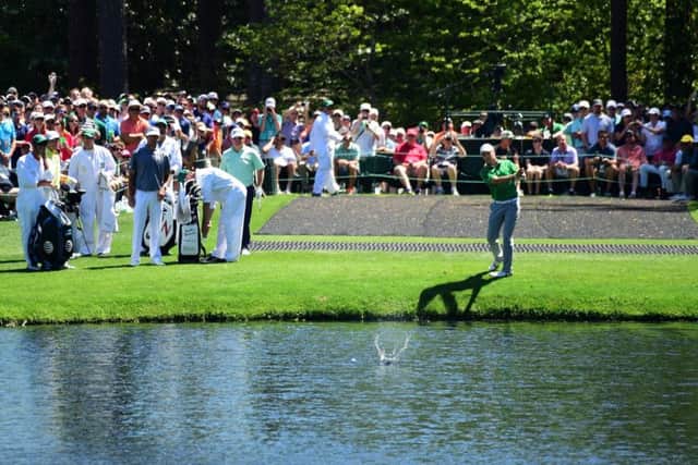 Jordan Spieth skips the ball across the water at the 16th hole during a practice round prior to the start of the Masters at Augusta. Picture: Harry How/Getty