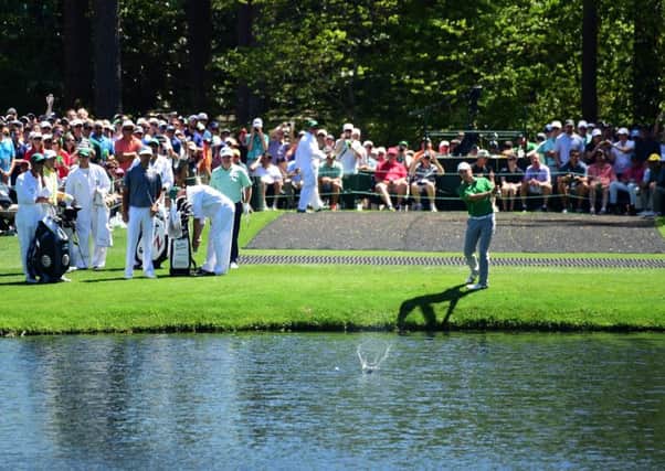 Jordan Spieth skips the ball across the water at the 16th hole during a practice round prior to the start of the Masters at Augusta. Picture: Harry How/Getty