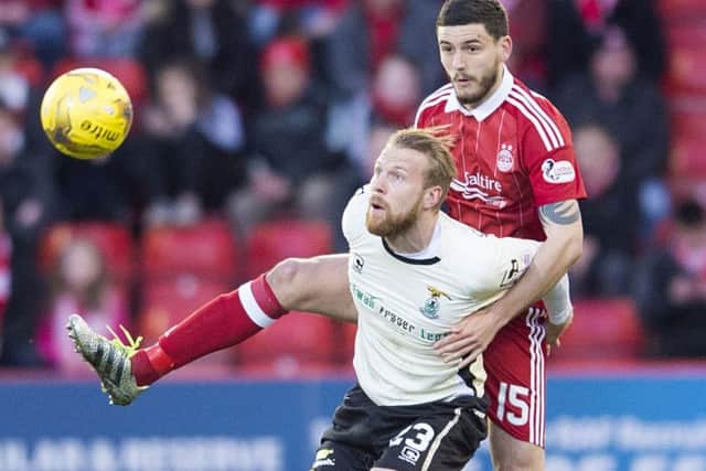 Anthony O'Connor, right, battles with Inverness striker Henri Anier during Aberdeen's win at Pittodrie on Tuesday night. Picture: SNS