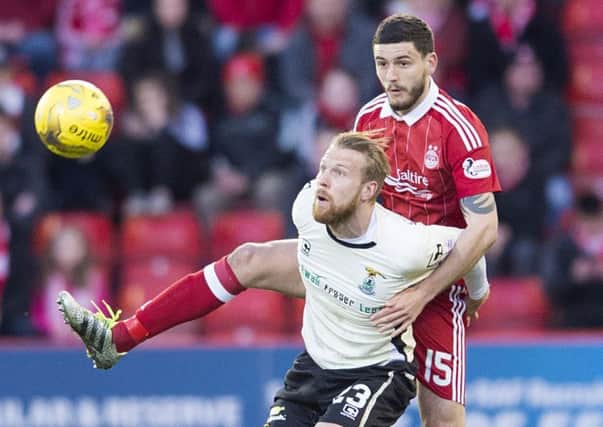 Anthony O'Connor, right, battles with Inverness striker Henri Anier during Aberdeen's win at Pittodrie on Tuesday night. Picture: SNS