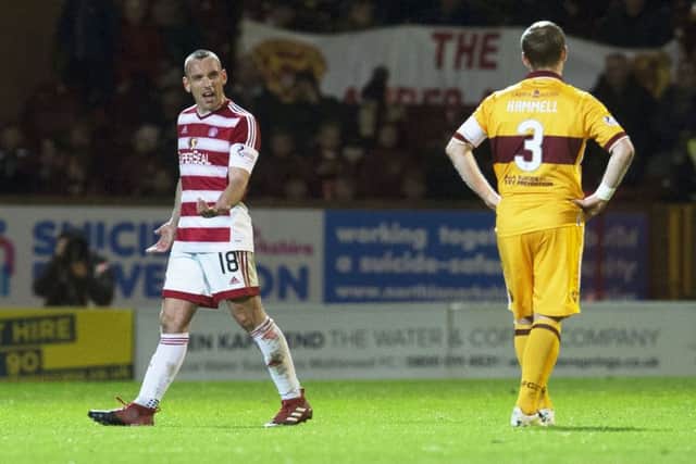 Hamilton's Darian Mackinnon walks off the pitch after his red card. Picture: SNS