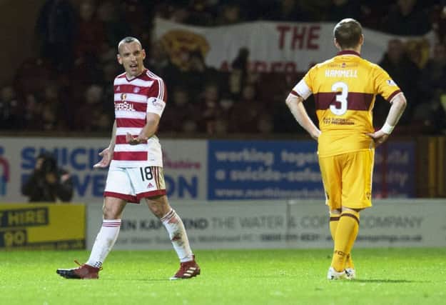 Hamilton's Darian Mackinnon walks off the pitch after his red card. Picture: SNS
