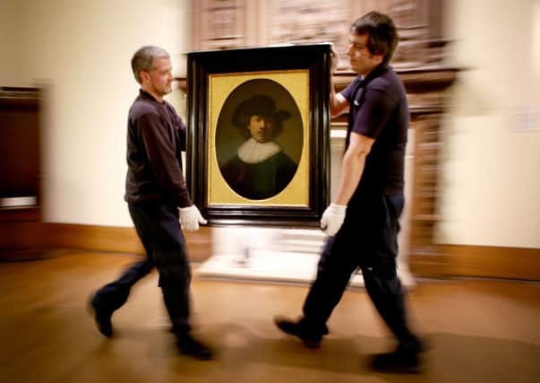Art technicians (from left) Andy Cavanagh and Paul McCall help to move a painting entitled 'Self Portrait' (1632) by Rembrandt at the Burrell Collection. Picture: Jane Barlow/PA Wire