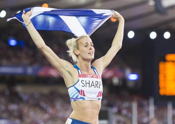 Lynsey Sharp proudly carries the Saltire after winning silver in the 800m at Hampden Park during the Glasgow 2014 games.