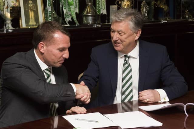 Brendan Rodgers and chief executive Peter Lawwell shake hands on the Celtic manager's new contract. Picture: SNS.