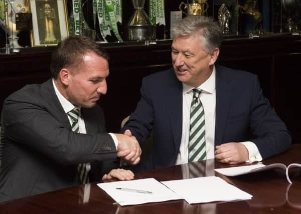 Brendan Rodgers and chief executive Peter Lawwell shake hands on the Celtic manager's new contract. Picture: SNS.