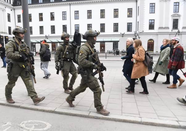 Police officers secure the area outside Stockholm Central station, on April 7, 2017 after a truck crashed into department store Ahlens on Drottninggatan, in central Stockholm. / AFP PHOTO / TT News Agency / Jessica GOW / Sweden OUTJESSICA GOW/AFP/Getty Images