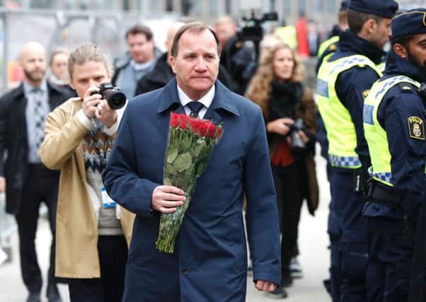 Swedish Prime Minister Stefan Lofven arrives to lay flowers at a makeshift memorial near the scene. Picture: Odd Andersen/AFP/Getty Images