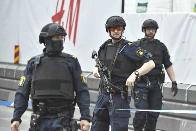 Armed police attend the scene after a truck crashed into a department store in Stockholm. Picture: Claudio Brescian/TT News Agency/AP